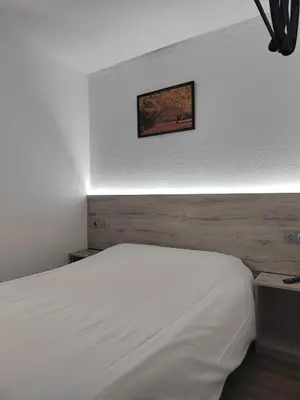 Un ou plusieurs lits dans un hébergement de l'établissement Alpha Hotel
