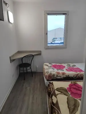 Un ou plusieurs lits dans un hébergement de l'établissement Alpha Hotel