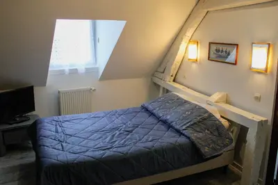 Un ou plusieurs lits dans un hébergement de l'établissement chambres d'hotes du colvert