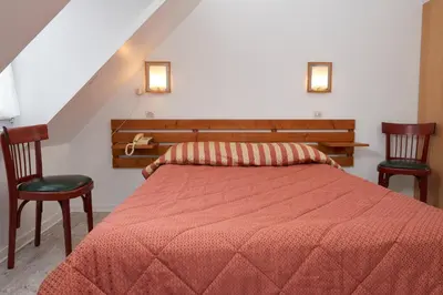 Un ou plusieurs lits dans un hébergement de l'établissement chambres d'hotes du colvert
