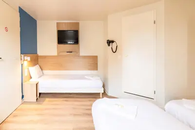 Un ou plusieurs lits dans un hébergement de l'établissement BRIT Hotel Rouen Nord - Barentin