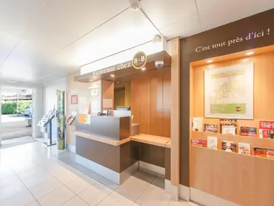 Un ou plusieurs lits dans un hébergement de l'établissement B&B HOTEL Herblay