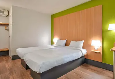 Un ou plusieurs lits dans un hébergement de l'établissement B&B HOTEL Herblay