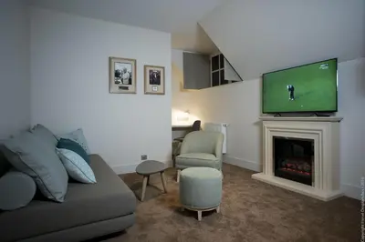 Télévision ou salle de divertissement dans l'établissement Grand Slam
