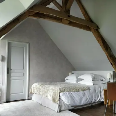 Un ou plusieurs lits dans un hébergement de l'établissement Clos Masure hôtel de campagne