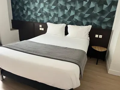 Un ou plusieurs lits dans un hébergement de l'établissement Hotel Au Spatial