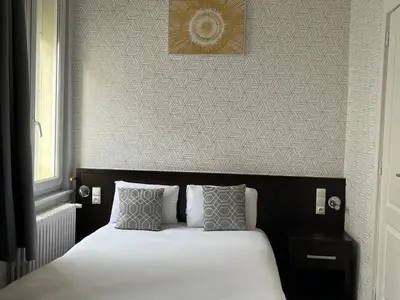 Un ou plusieurs lits dans un hébergement de l'établissement Hotel Au Spatial