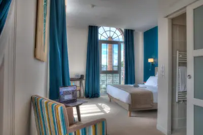 Un ou plusieurs lits dans un hébergement de l'établissement Hôtel de la Tabletterie
