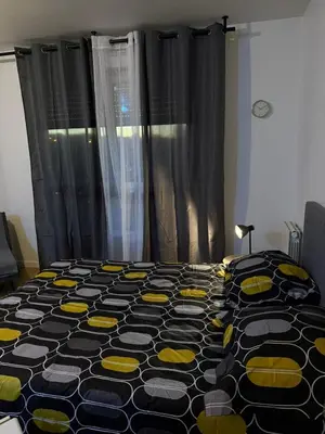 Un ou plusieurs lits dans un hébergement de l'établissement Appartements Sully