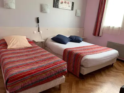 Un ou plusieurs lits dans un hébergement de l'établissement Hotel du Haut Marais