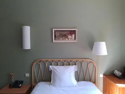 Un ou plusieurs lits dans un hébergement de l'établissement Hostellerie Du Lys