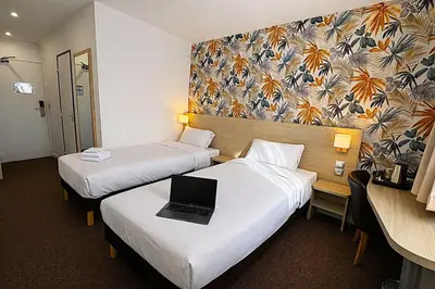 Un ou plusieurs lits dans un hébergement de l'établissement Logis Hotel Altina