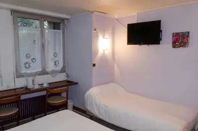 Un ou plusieurs lits dans un hébergement de l'établissement Hôtel le Relais
