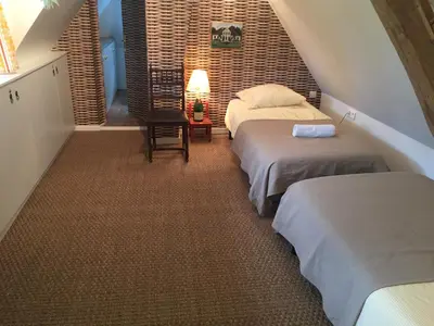 Un ou plusieurs lits dans un hébergement de l'établissement Charmante Maison entre les Pommiers