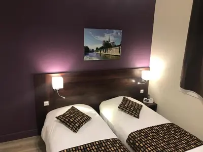 Un ou plusieurs lits dans un hébergement de l'établissement HÔTEL LES IRIS