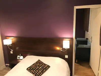 Un ou plusieurs lits dans un hébergement de l'établissement HÔTEL LES IRIS