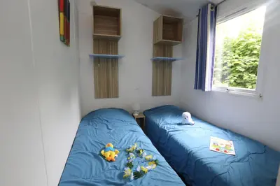 Un ou plusieurs lits dans un hébergement de l'établissement Camping Le Val de Trie