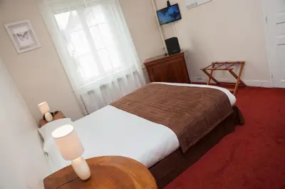 Un ou plusieurs lits dans un hébergement de l'établissement Hôtel Moderne