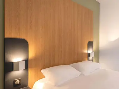 Un ou plusieurs lits dans un hébergement de l'établissement B&B HOTEL Le Tréport Friville