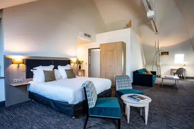 Un ou plusieurs lits dans un hébergement de l'établissement Hôtel Spa Marotte