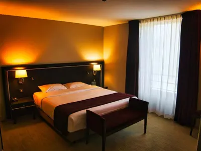 Un ou plusieurs lits dans un hébergement de l'établissement Amicitia - Hôtel & Restaurant