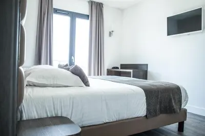 Un ou plusieurs lits dans un hébergement de l'établissement Hotel Les Galets