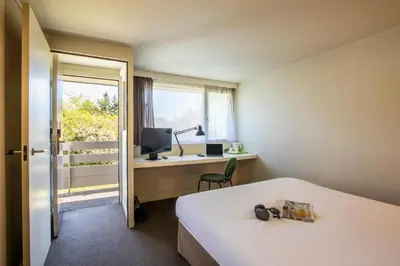Un ou plusieurs lits dans un hébergement de l'établissement Campanile Hotel Beauvais