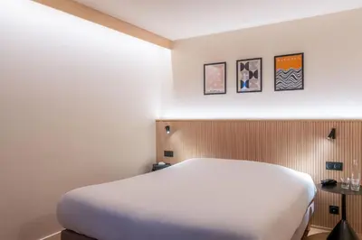 Un ou plusieurs lits dans un hébergement de l'établissement Grand Hôtel De La Seine