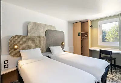 Un ou plusieurs lits dans un hébergement de l'établissement B&B HOTEL Rouen Centre Rive Droite
