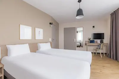 Un ou plusieurs lits dans un hébergement de l'établissement Appart'City Confort Amiens Gare