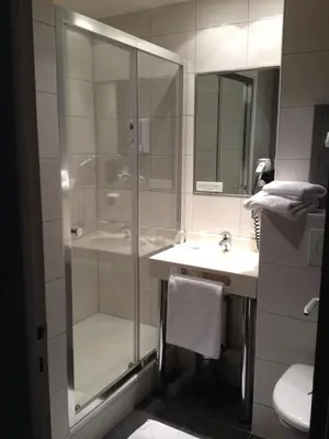 Salle de bains dans l'établissement LOGIS Hôtel & Restaurant - Les Arcades
