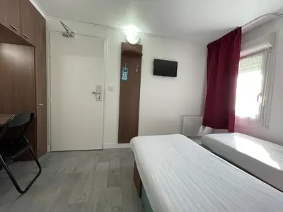 Un ou plusieurs lits dans un hébergement de l'établissement Kyriad Direct Val de Reuil