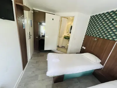 Un ou plusieurs lits dans un hébergement de l'établissement Kyriad Direct Val de Reuil