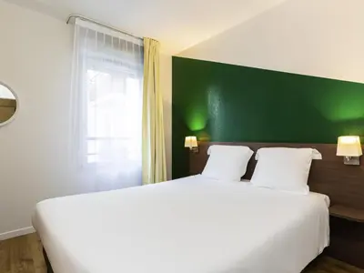 Un ou plusieurs lits dans un hébergement de l'établissement Aparthotel Adagio Access Carrières Sous Poissy