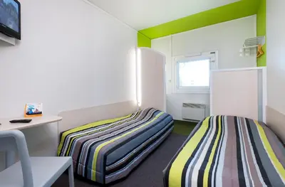 Un ou plusieurs lits dans un hébergement de l'établissement Eco hôtel Rouen Louviers Val de Reuil