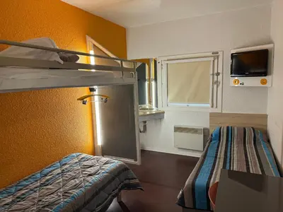 Un ou plusieurs lits dans un hébergement de l'établissement Hotel First Eco Dieppe