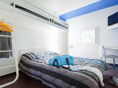 Un ou plusieurs lits dans un hébergement de l'établissement Hotel First Eco Dieppe