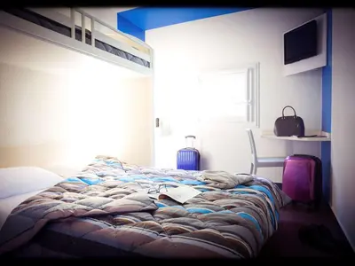 Un ou plusieurs lits dans un hébergement de l'établissement Hotel First Eco Dieppe