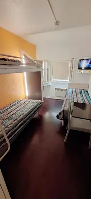 Un ou plusieurs lits dans un hébergement de l'établissement Hotel First Eco Dieppe