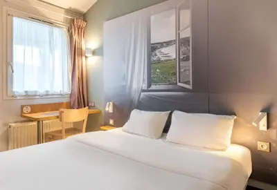 Un ou plusieurs lits dans un hébergement de l'établissement B&B HOTEL Dieppe