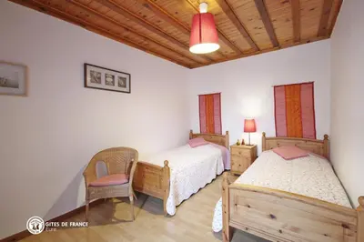 Un ou plusieurs lits dans un hébergement de l'établissement Les Chambres du Chataignier