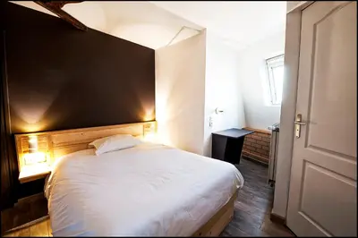 Un ou plusieurs lits dans un hébergement de l'établissement Hôtel du Nord