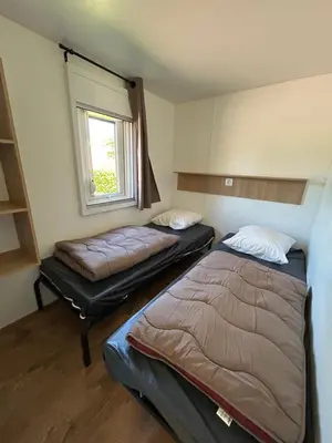 Un ou plusieurs lits dans un hébergement de l'établissement Camping les Marguerites