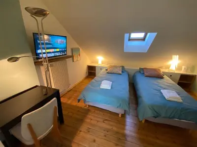 Un ou plusieurs lits dans un hébergement de l'établissement La Chambre Claire