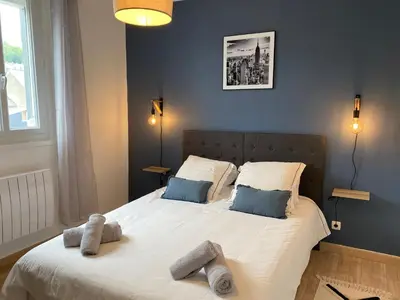 Un ou plusieurs lits dans un hébergement de l'établissement Family Appart 2