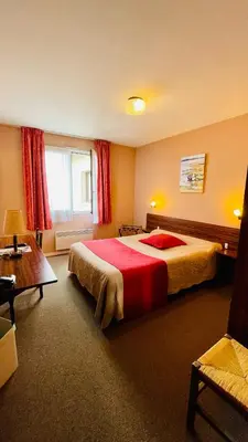 Un ou plusieurs lits dans un hébergement de l'établissement Hôtel le cygne