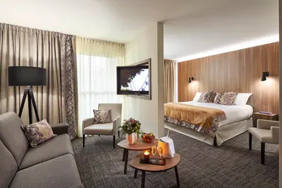 Un ou plusieurs lits dans un hébergement de l'établissement Le Forges Hotel