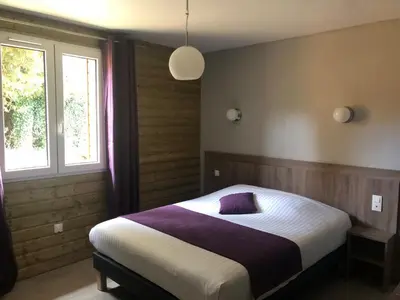 Un ou plusieurs lits dans un hébergement de l'établissement Logis Hotel Le Val Sarah