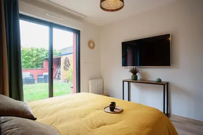Un ou plusieurs lits dans un hébergement de l'établissement Appartement Les Jardins de Jules Verne - Côté Jardin