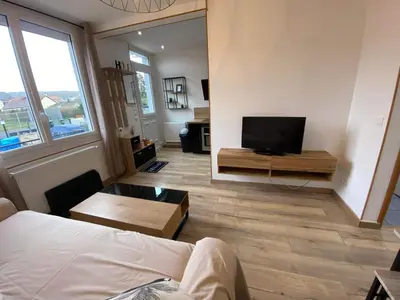 Télévision ou salle de divertissement dans l'établissement Maison de ville
